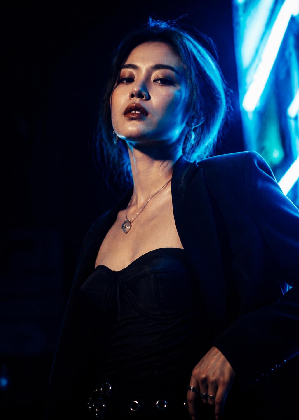 Editorial portrait under blue nightlife lighting