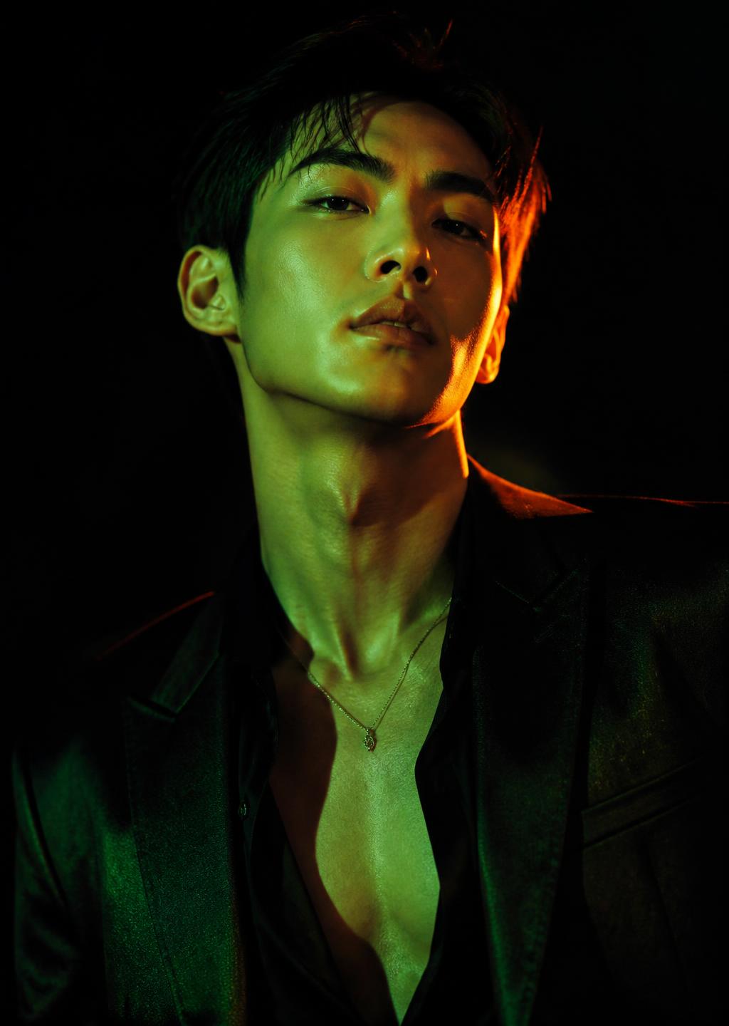 Editorial portrait under emerald and orange lighting